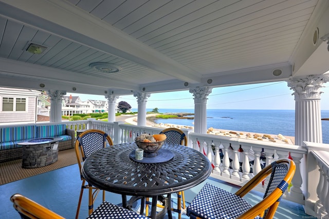 view of patio / terrace featuring a water view and a fire pit