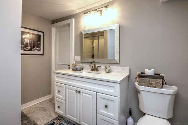 bathroom featuring vanity, toilet, and tile patterned flooring