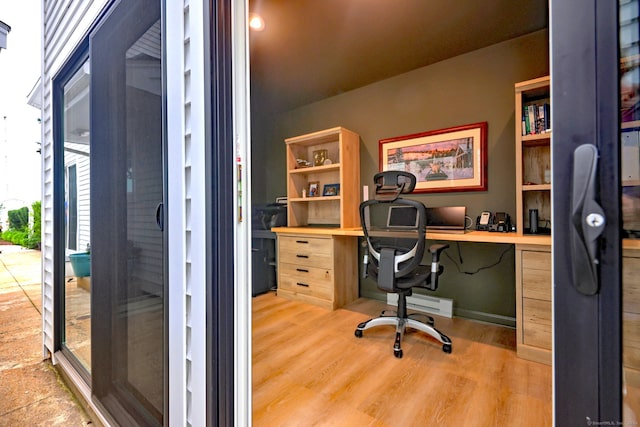 home office featuring built in desk and light hardwood / wood-style floors