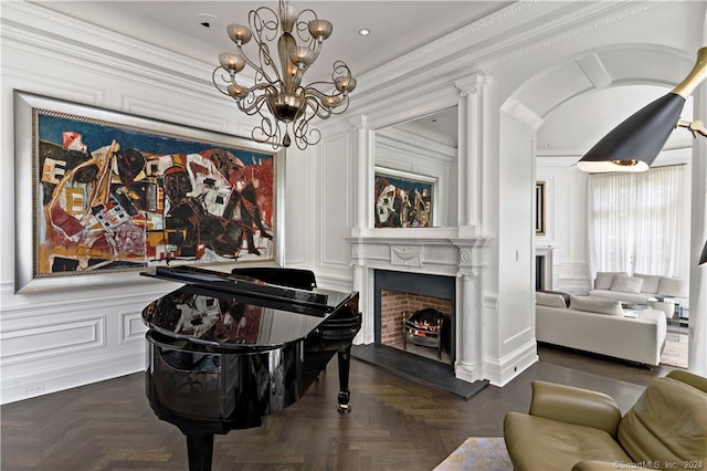 interior space featuring ornamental molding, a notable chandelier, and dark parquet floors