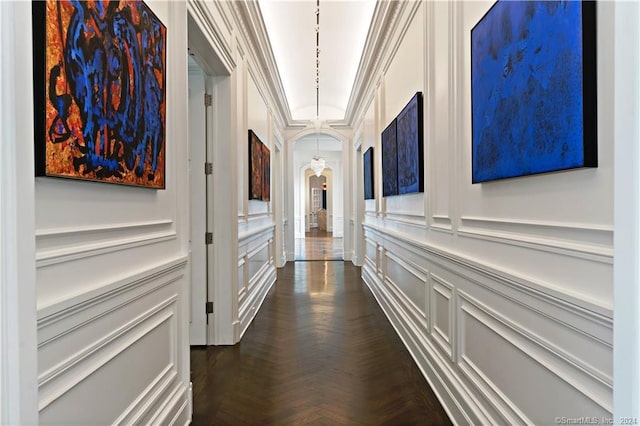 hall with crown molding and dark parquet floors