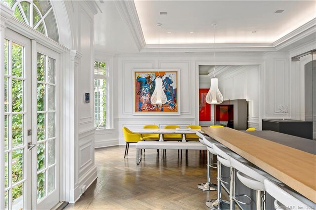 interior space featuring crown molding and dark parquet floors