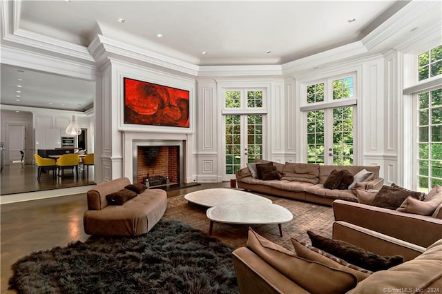 living room featuring crown molding, a healthy amount of sunlight, and concrete floors