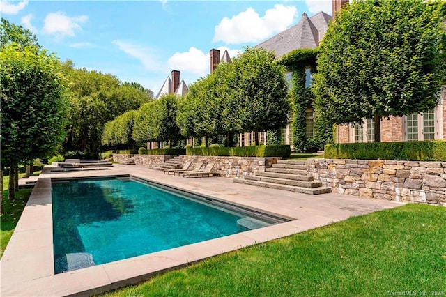 view of swimming pool featuring a patio area