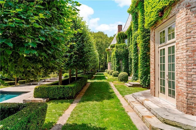 view of yard featuring french doors