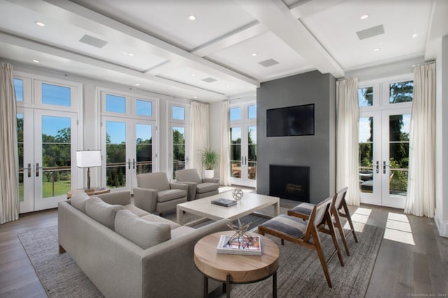 living room with a fireplace, beam ceiling, dark hardwood / wood-style flooring, and french doors