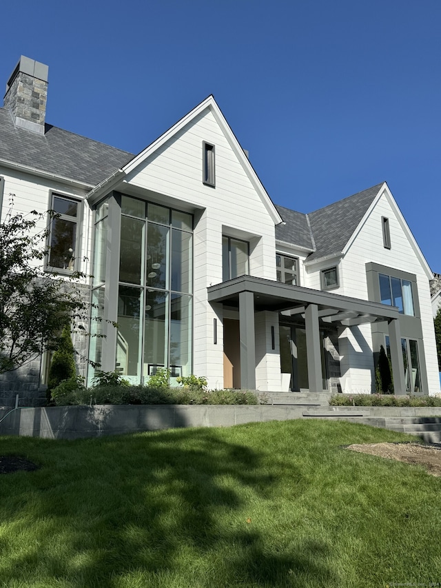 rear view of house with a lawn