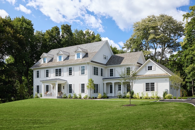 view of front of home featuring a front lawn and covered porch