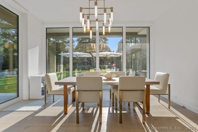 dining area featuring light wood-type flooring and a chandelier