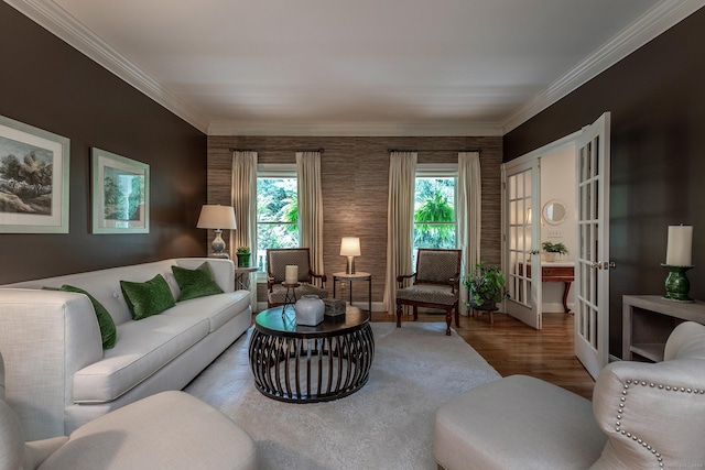 living room featuring french doors, a healthy amount of sunlight, crown molding, and wood finished floors