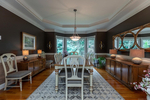 dining space featuring crown molding and wood finished floors