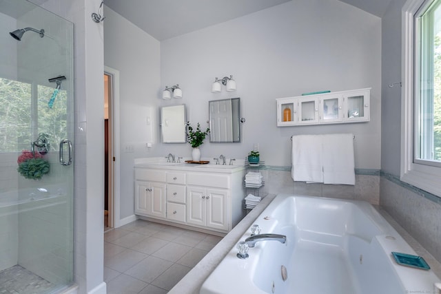 bathroom featuring a whirlpool tub, a stall shower, tile patterned flooring, and a sink