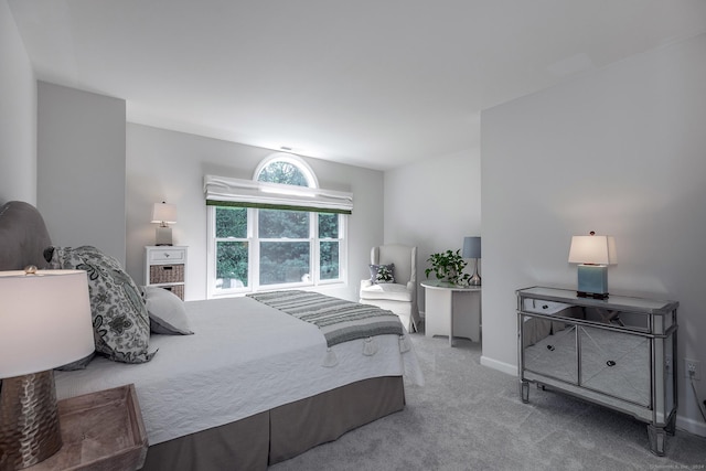 carpeted bedroom featuring baseboards