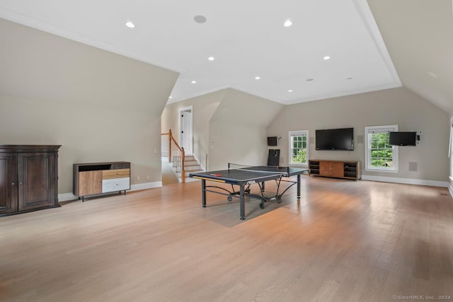 rec room with light wood-type flooring and vaulted ceiling