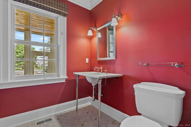 bathroom featuring tile patterned floors, toilet, and ornamental molding