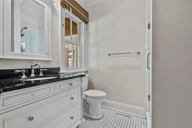 bathroom with tile patterned floors, ornamental molding, vanity, and toilet