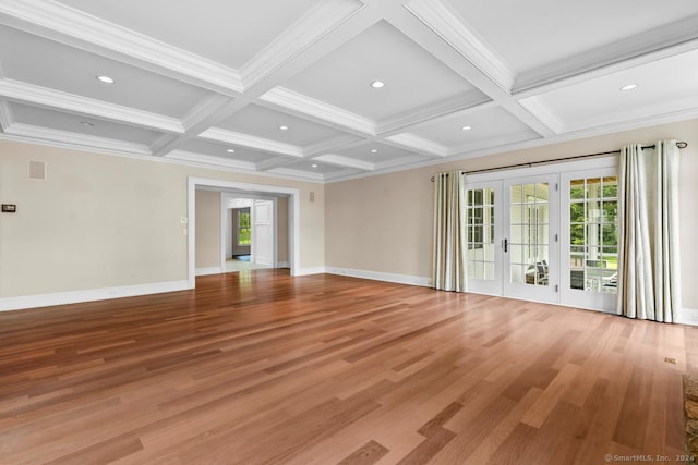 unfurnished living room featuring coffered ceiling, french doors, wood-type flooring, and a healthy amount of sunlight