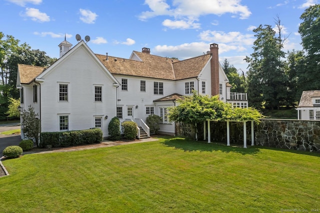 back of house with a lawn