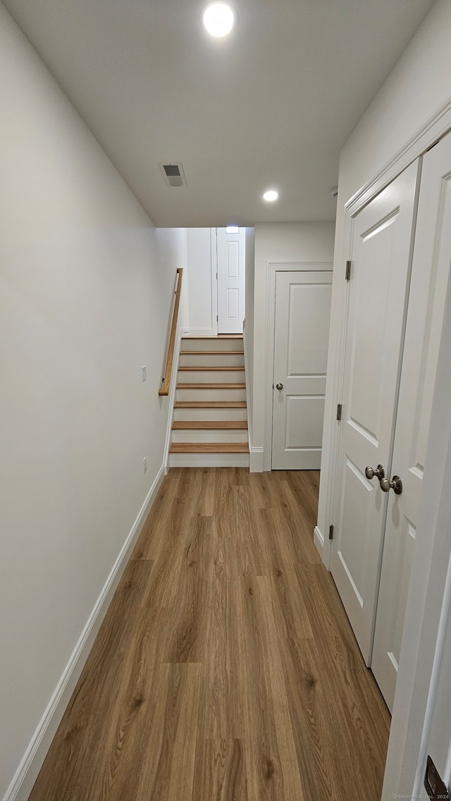 stairs featuring wood-type flooring