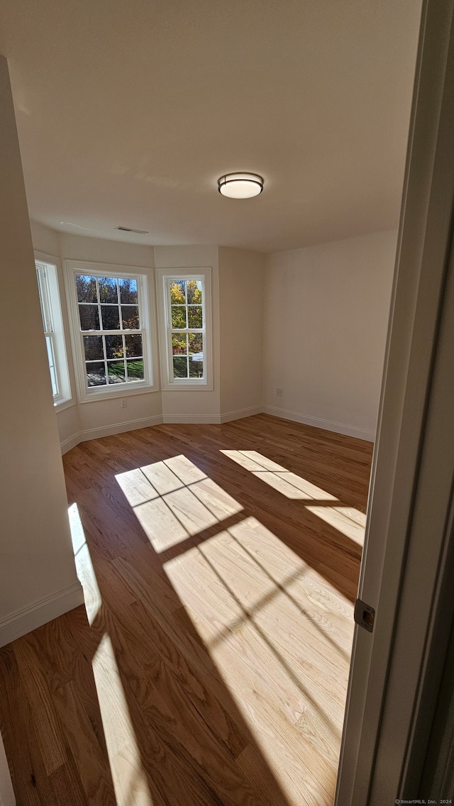 empty room with hardwood / wood-style flooring