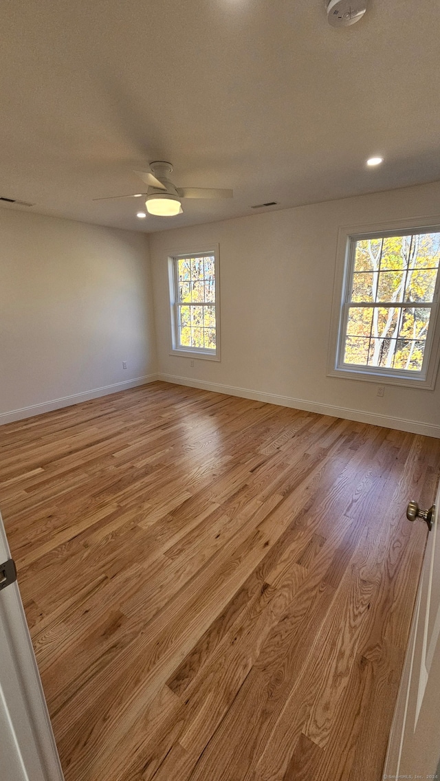 empty room featuring light hardwood / wood-style flooring and ceiling fan