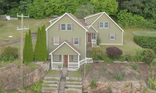 view of front facade with a front yard and covered porch