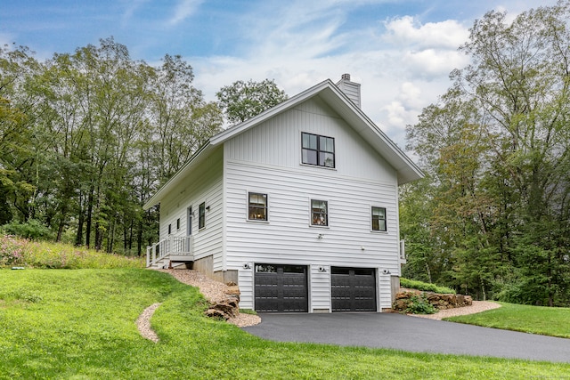 view of side of home with a garage and a yard