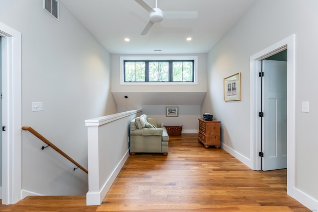 sitting room featuring light hardwood / wood-style floors and ceiling fan