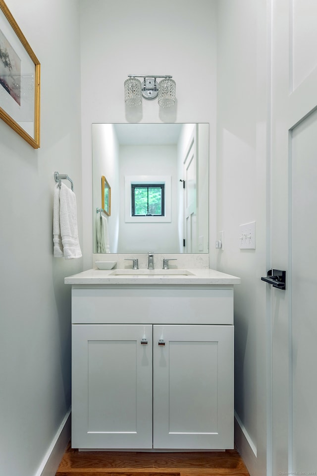 bathroom with vanity and hardwood / wood-style floors