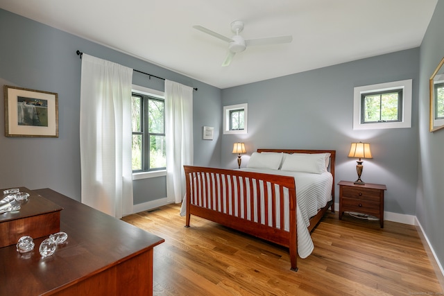 bedroom with light hardwood / wood-style floors and ceiling fan