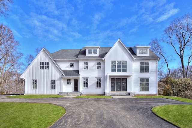 modern farmhouse style home with a front yard