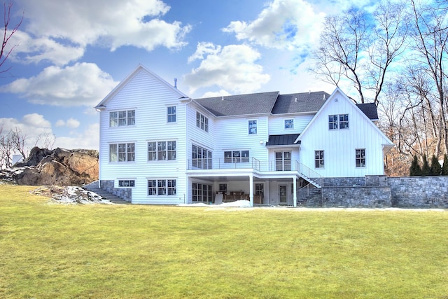 rear view of house featuring a yard