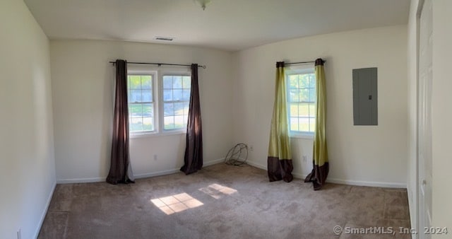 carpeted empty room with electric panel