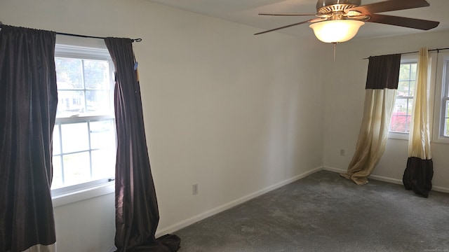 empty room featuring carpet floors, a healthy amount of sunlight, and ceiling fan