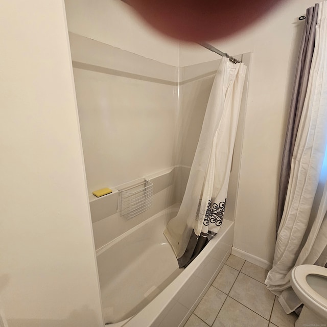 bathroom with toilet, tile patterned flooring, and shower / tub combo