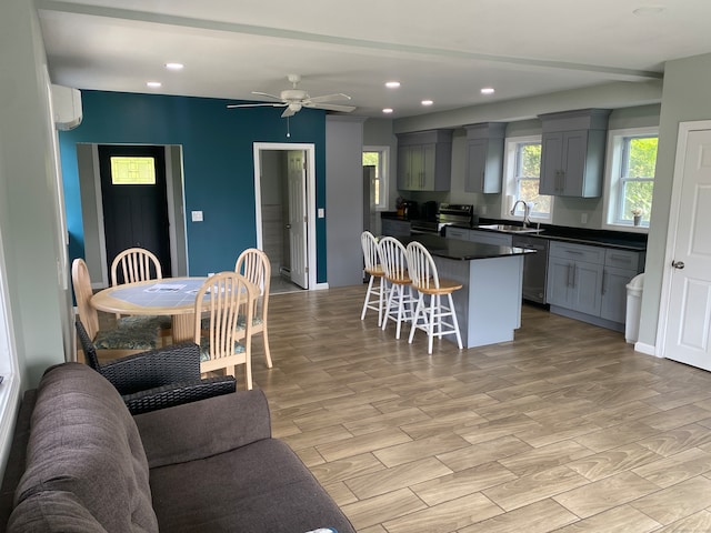 kitchen with ceiling fan, sink, gray cabinets, stainless steel appliances, and a wall mounted AC