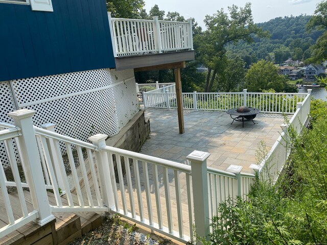 wooden deck featuring a patio and a fire pit