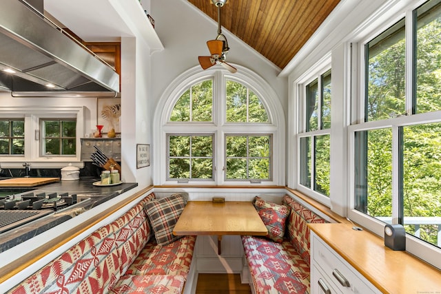 sunroom featuring lofted ceiling and wooden ceiling