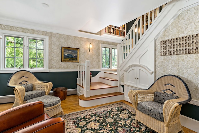 sitting room with baseboards, stairway, wood finished floors, and wallpapered walls