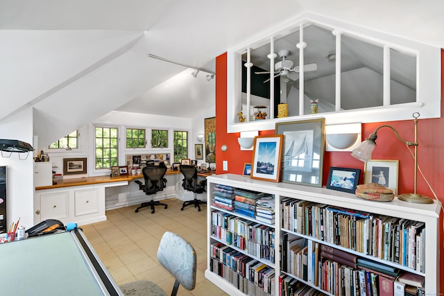 office with lofted ceiling, ceiling fan, light tile patterned flooring, and built in study area