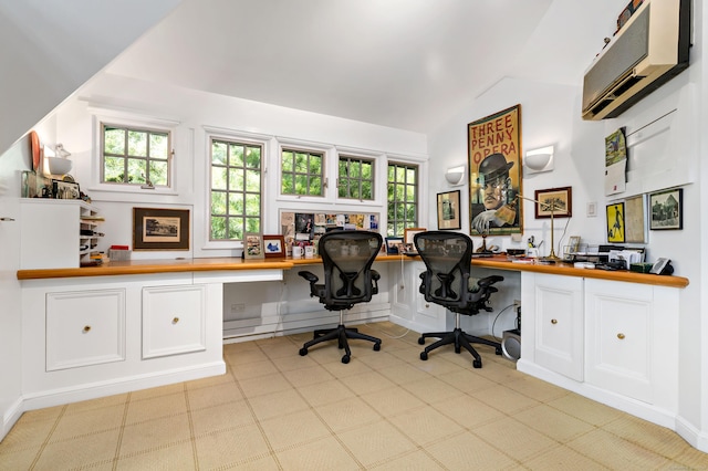 home office featuring a healthy amount of sunlight, built in study area, and an AC wall unit