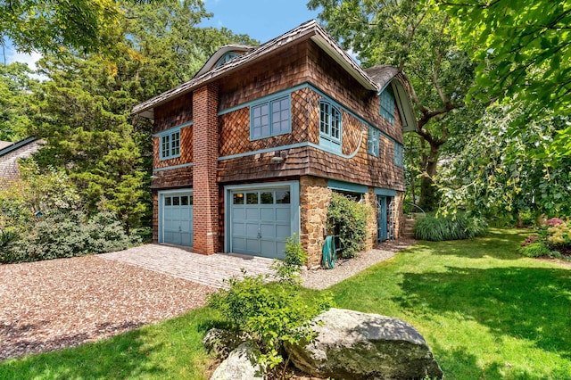 view of side of property featuring a yard and an attached garage