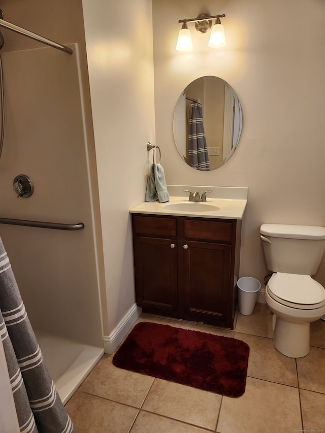 bathroom with tile patterned floors, a shower with curtain, toilet, and vanity