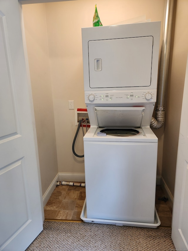 laundry area with stacked washer and dryer