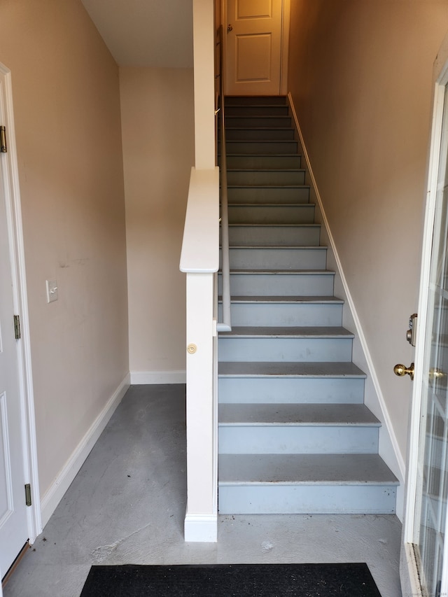 stairway featuring concrete flooring