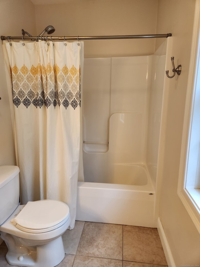 bathroom with toilet, shower / tub combo, and tile patterned flooring