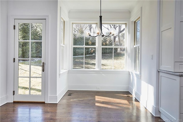 doorway featuring dark hardwood / wood-style floors and a chandelier