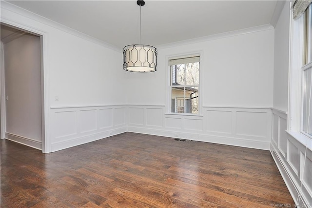 empty room featuring dark hardwood / wood-style flooring and crown molding