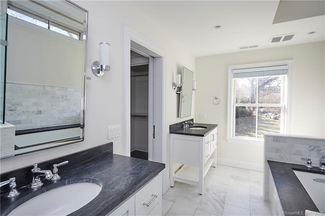 bathroom featuring double sink vanity, a bath, plenty of natural light, and tile patterned flooring