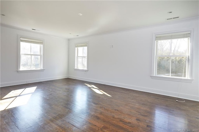 unfurnished room featuring dark hardwood / wood-style floors and ornamental molding